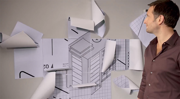 An image of a guy watching unfolding paper